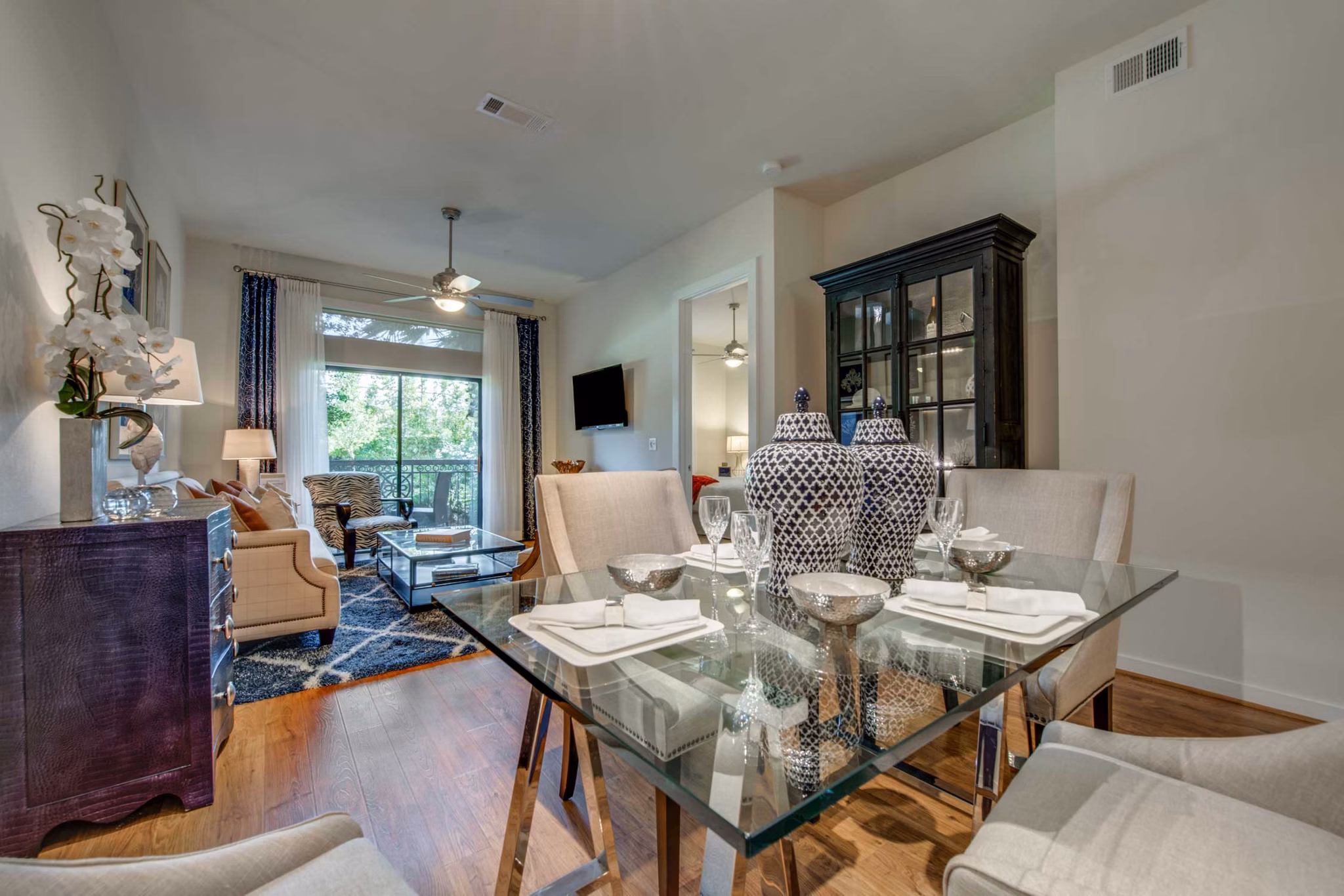 Dining area with contemporary design and elegant lighting in Grove at Wilcrest Apartments, showcasing luxury living options