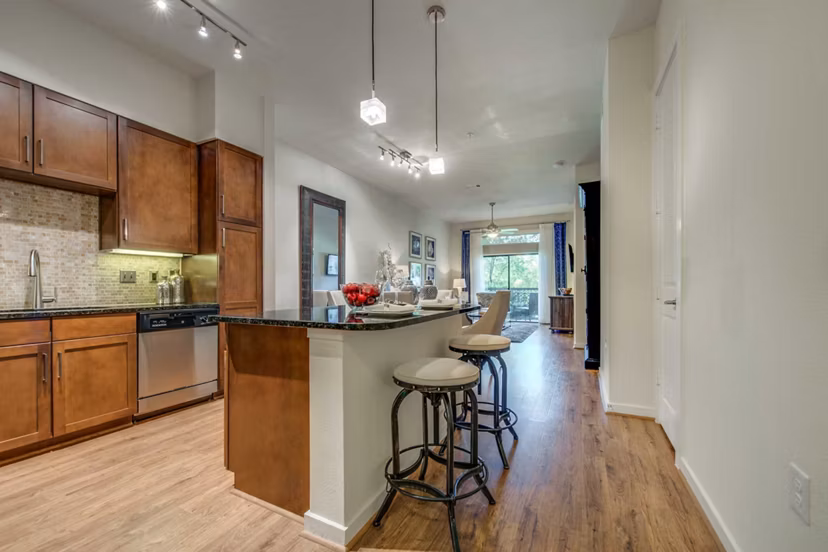 Modern kitchen with stainless steel appliances at Grove at Wilcrest Apartments