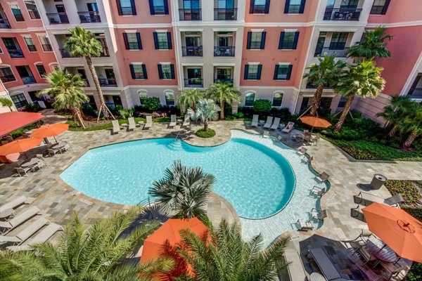 Luxurious pool area with lounging chairs at Grove at Wilcrest Apartments