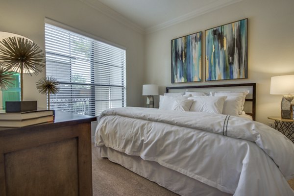 Cozy bedroom with natural lighting at Jackson Hill Apartments