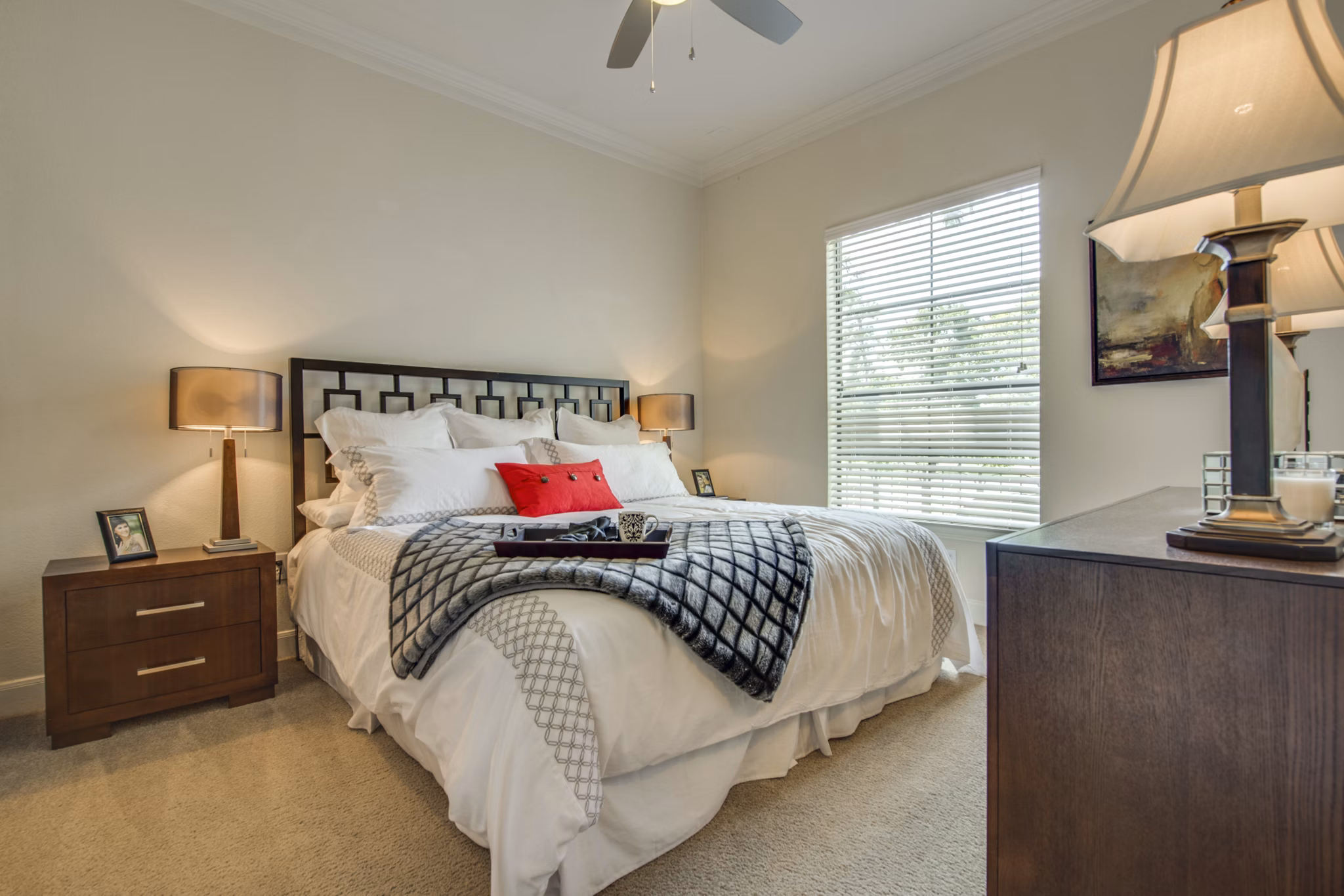 Cozy bedroom with modern furnishings and natural light at Jackson Hill Apartments