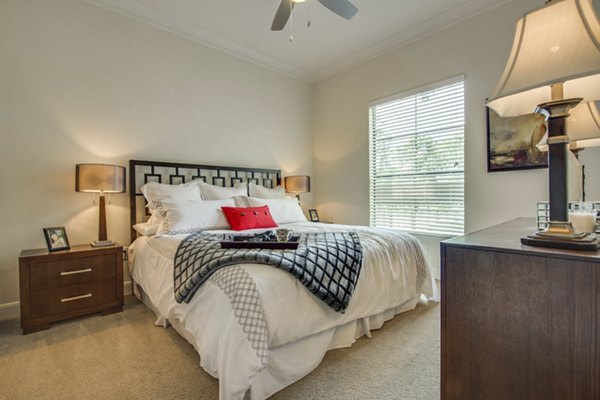 Cozy bedroom with modern furnishings and natural light at Jackson Hill Apartments