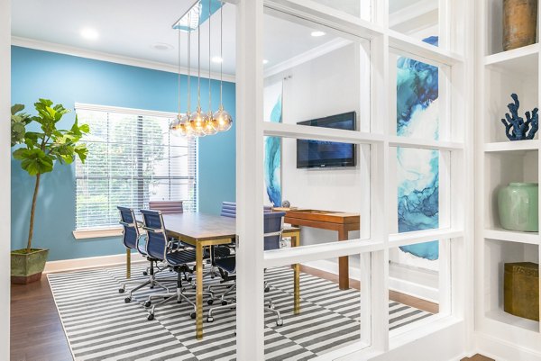 Meeting room with large conference table at Jackson Hill Apartments, perfect for business gatherings and events
