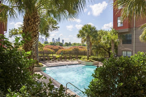 Relaxing outdoor pool at Jackson Hill Apartments with poolside seating