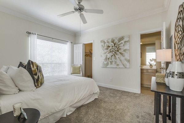 Cozy bedroom with modern furnishings at Las Palmas Apartments