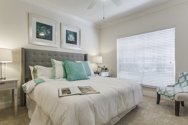 Modern bedroom with elegant decor and natural lighting at Las Palmas Apartments