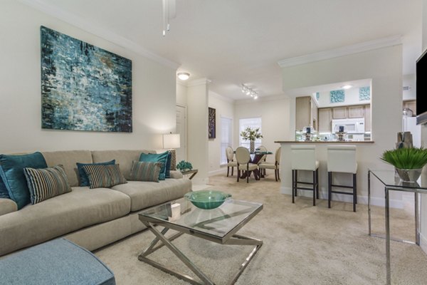 Living room with contemporary decor and natural light at Las Palmas Apartments