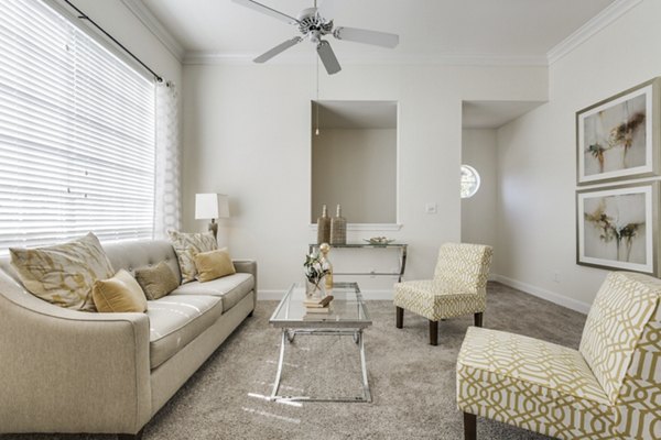 Spacious living room with contemporary furnishings at Las Palmas Apartments