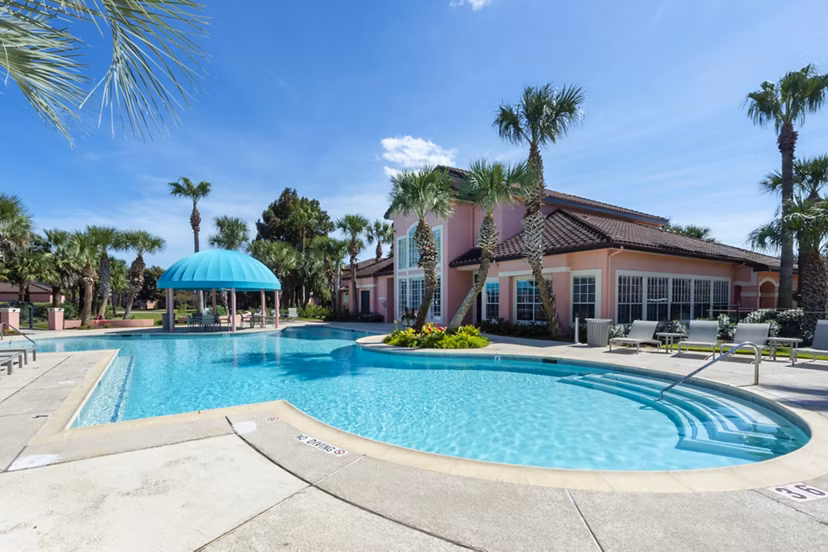 Resort-style pool with comfortable lounge chairs at Las Palmas Apartments