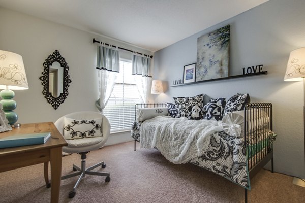 Bedroom with modern furnishings and neutral palette at Sabo Village Apartments