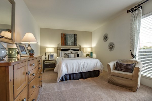 Cozy bedroom with a large window and modern decor at Sabo Village Apartments luxury rentals