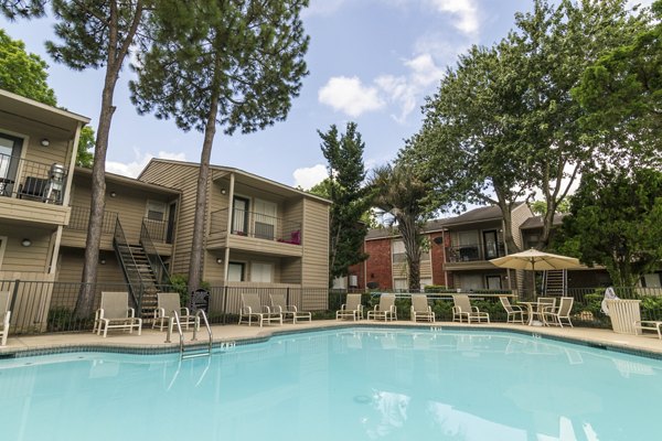 Outdoor pool with lounge chairs at Sabo Village Apartments, a luxury living community offering resort-style amenities