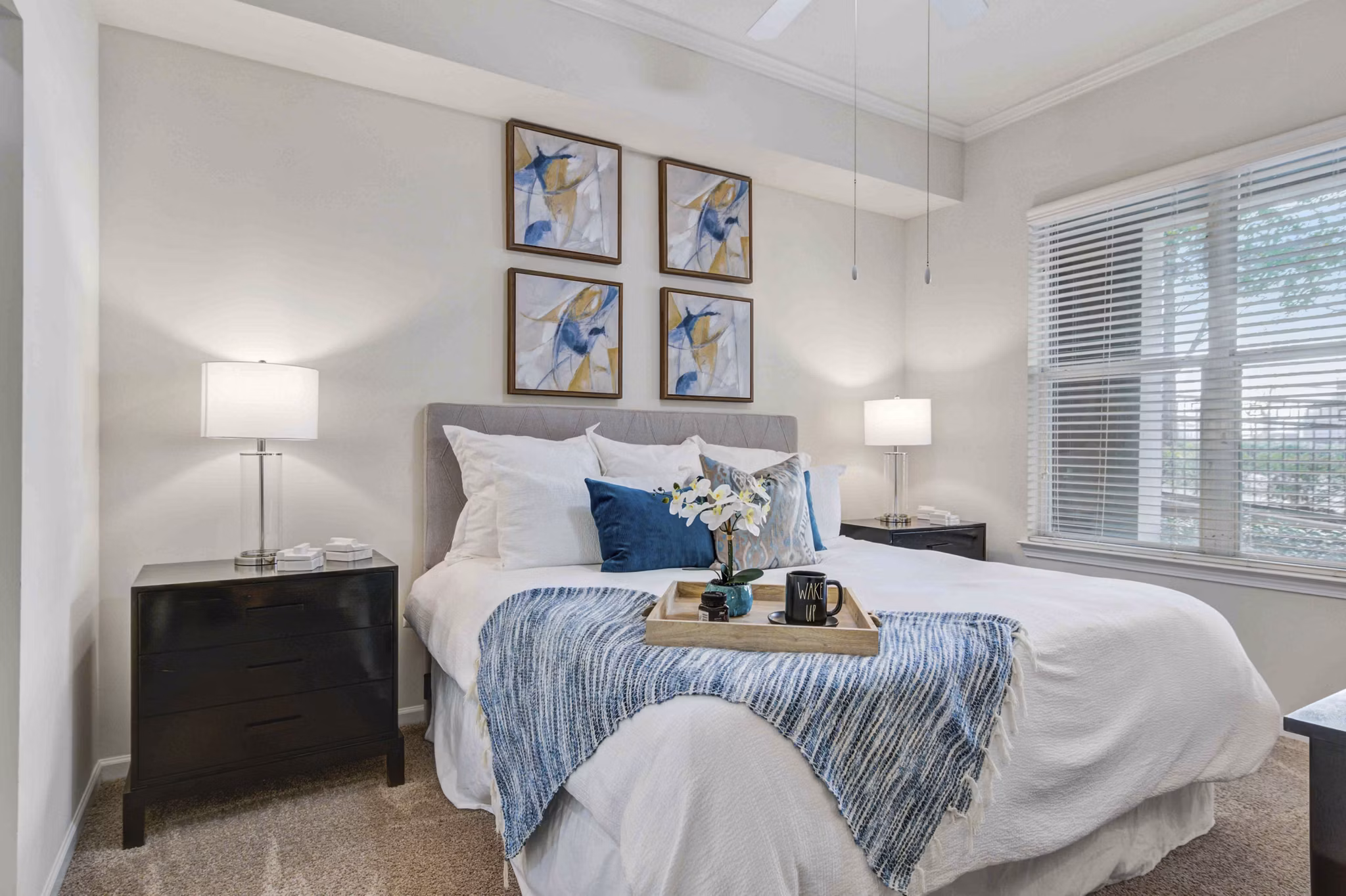Kingsboro Luxury Apartments: Elegant bedroom with cozy decor and large windows offering natural light