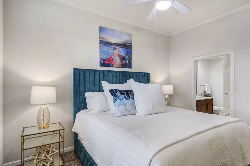 Bedroom with elegant decor and ample natural light at Kingsboro Luxury Apartments
