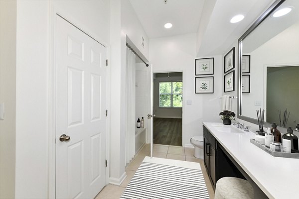 Kingsboro Luxury Apartments: Modern bathroom with sleek fixtures and marble countertop