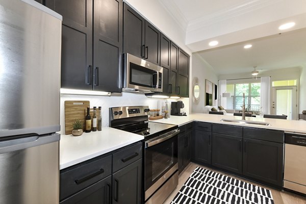 Modern kitchen featuring stainless steel appliances and granite countertops at Kingsboro Luxury Apartments