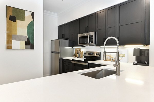 Modern kitchen featuring stainless steel appliances and granite countertops at Kingsboro Luxury Apartments