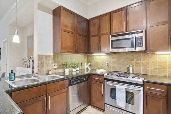 Kitchen with sleek countertops and modern appliances at Kingsboro Luxury Apartments
