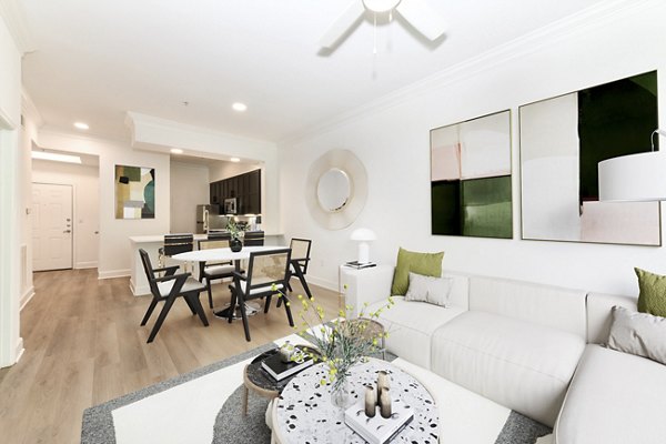 Elegant living room with modern decor at Kingsboro Luxury Apartments, featuring ample natural light and premium finishes