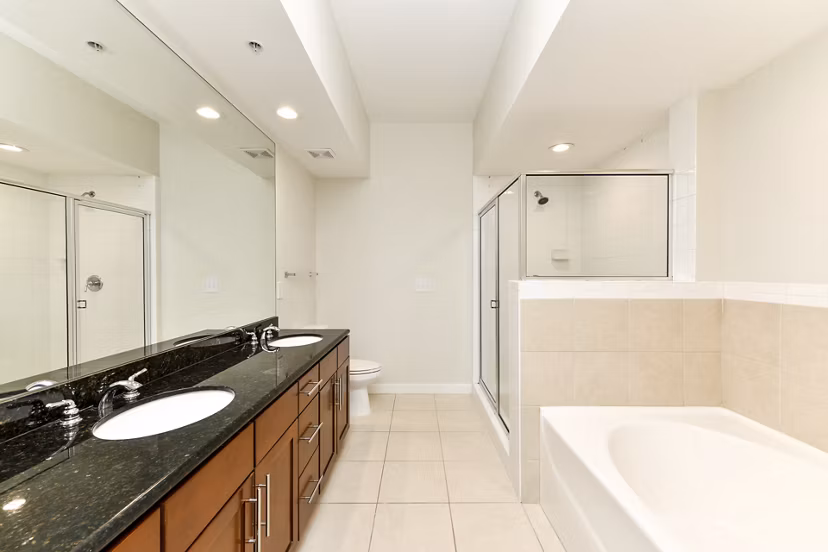 Modern bathroom with marble countertops and sleek fixtures at Peachtree Dunwoody Place Apartments