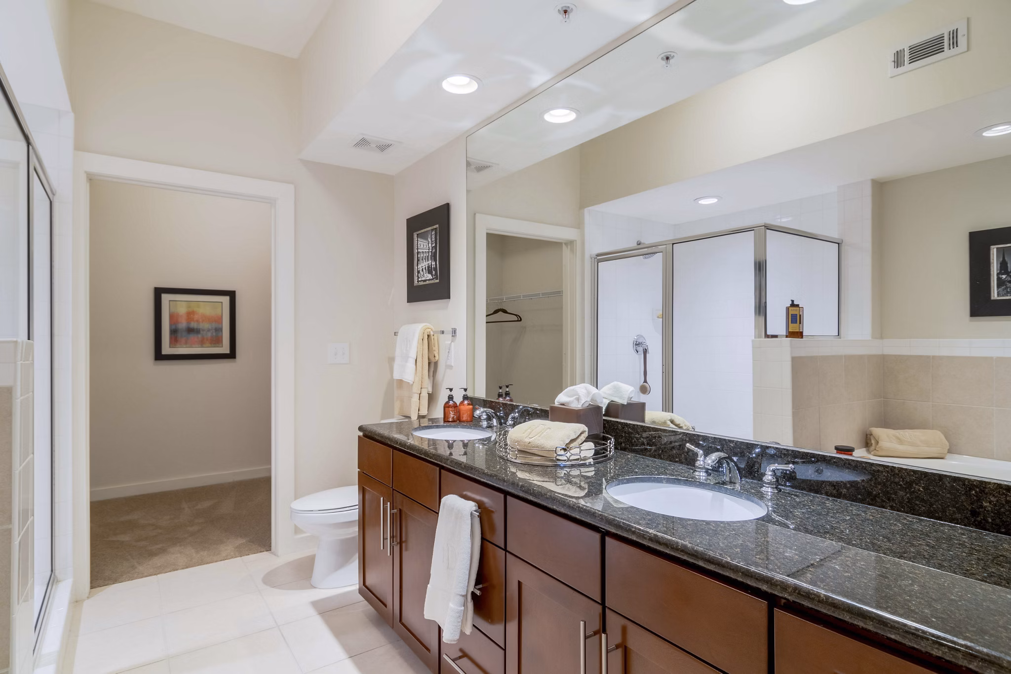 Elegant bathroom with marble countertops and dual sinks at Peachtree Dunwoody Place Apartments