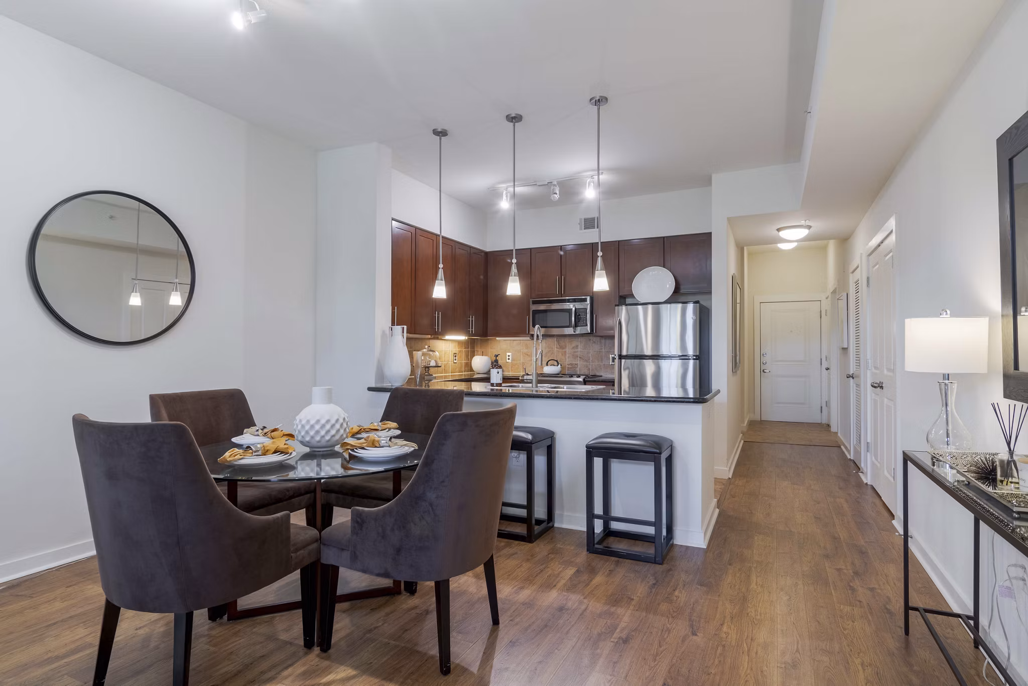 Dining room with elegant lighting and contemporary furniture at Peachtree Dunwoody Place Apartments