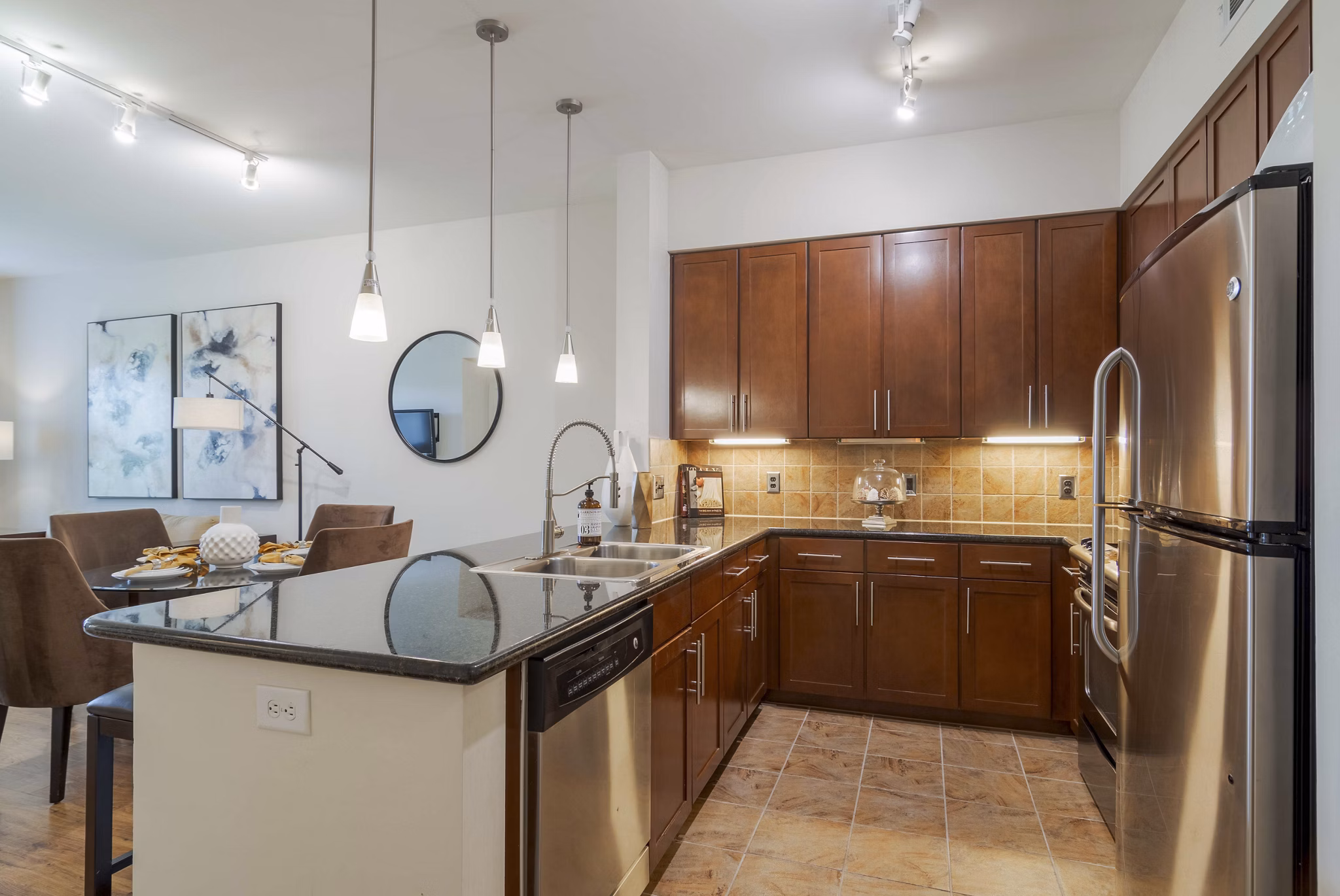 Contemporary kitchen featuring stainless steel appliances at Peachtree Dunwoody Place Apartments