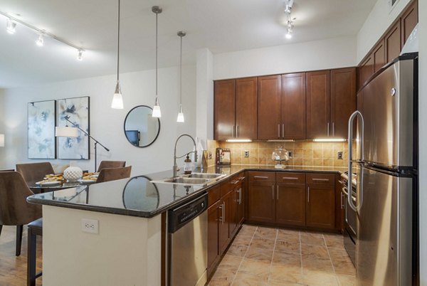 Contemporary kitchen featuring stainless steel appliances at Peachtree Dunwoody Place Apartments
