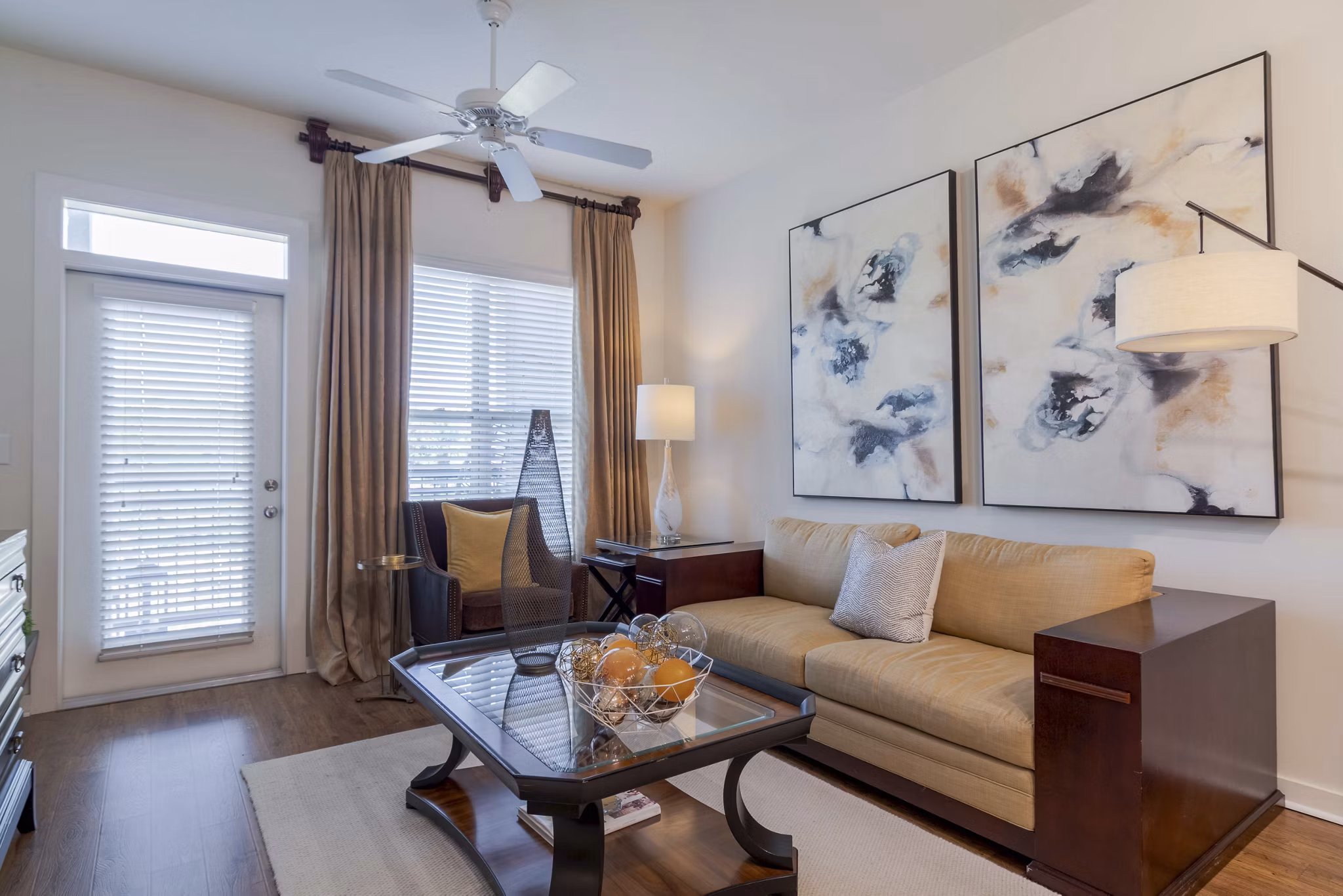 Spacious living room with hardwood floors and modern decor in Peachtree Dunwoody Place Apartments