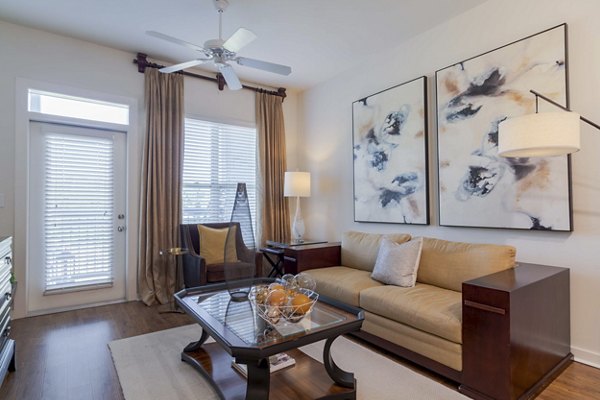 Spacious living room with hardwood floors and modern decor in Peachtree Dunwoody Place Apartments