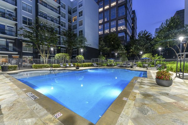 Outdoor pool at Peachtree Dunwoody Place Apartments with sundeck and lounge chairs, offering a relaxing space for residents