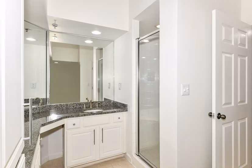 Luxurious bathroom featuring marble countertops and modern fixtures at Phipps Place Apartments