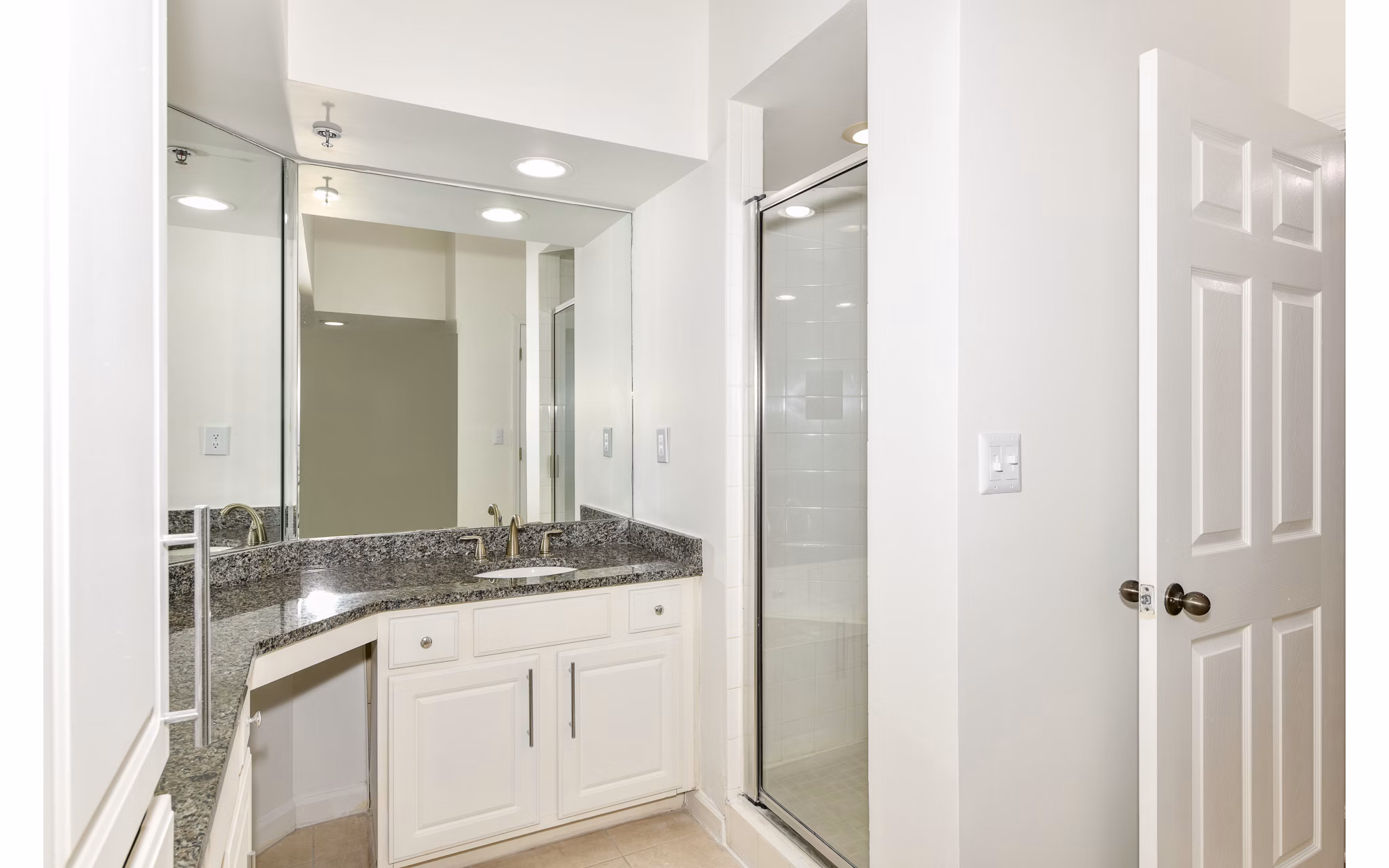 Luxurious bathroom featuring marble countertops and modern fixtures at Phipps Place Apartments