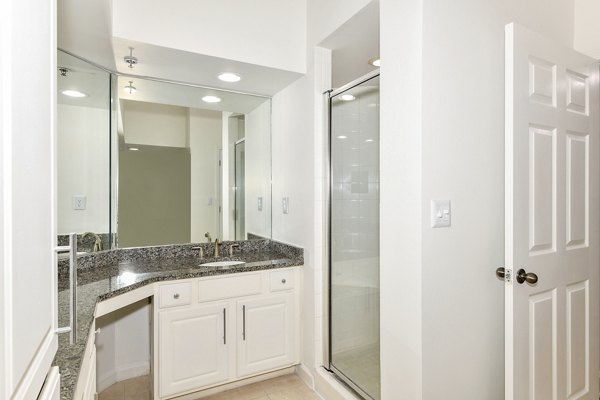 Luxurious bathroom featuring marble countertops and modern fixtures at Phipps Place Apartments