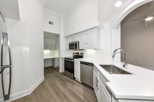 Modern kitchen with stainless steel appliances at Phipps Place Apartments, luxury living in the heart of the city