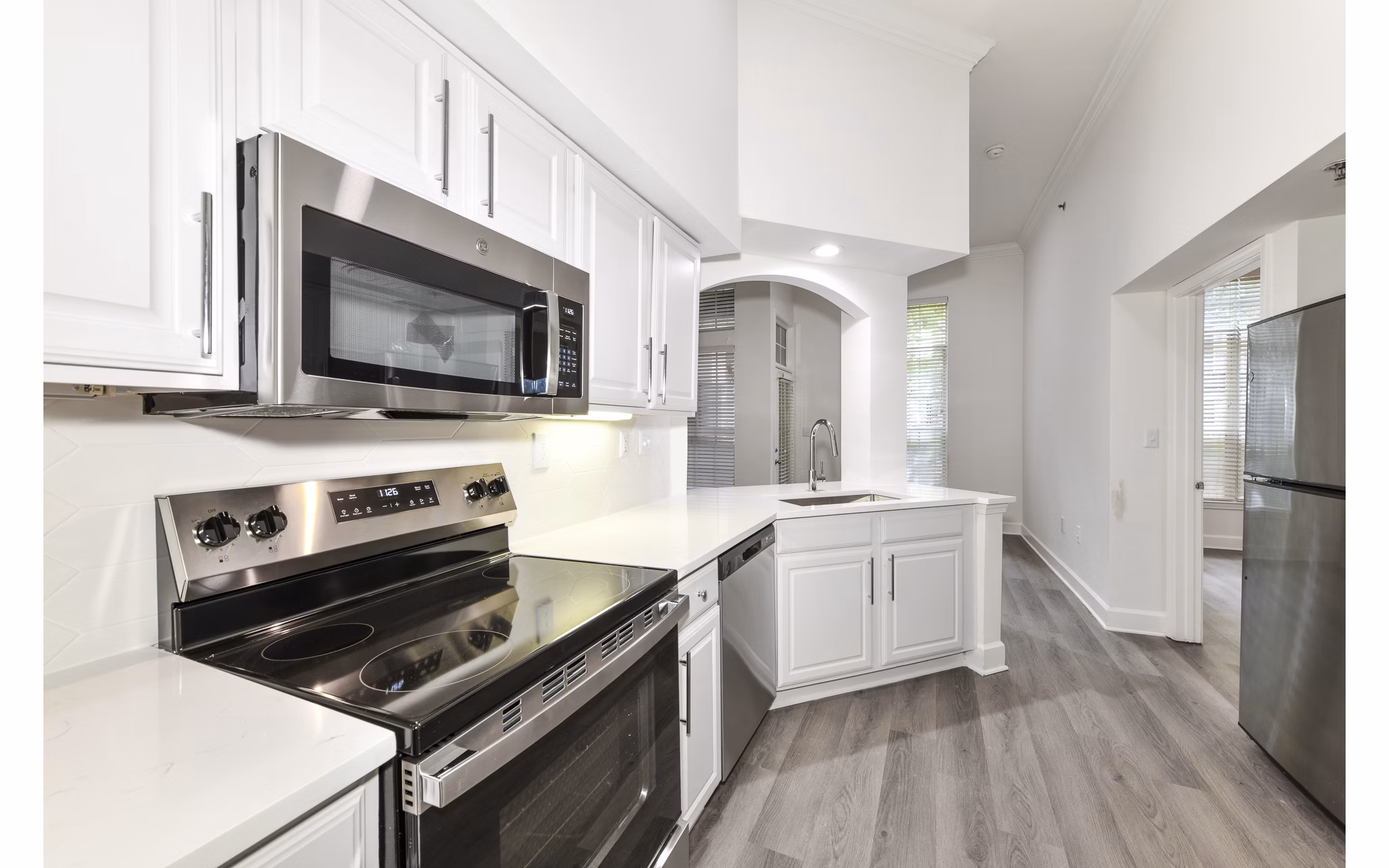 Contemporary kitchen with stainless steel appliances at Phipps Place Apartments