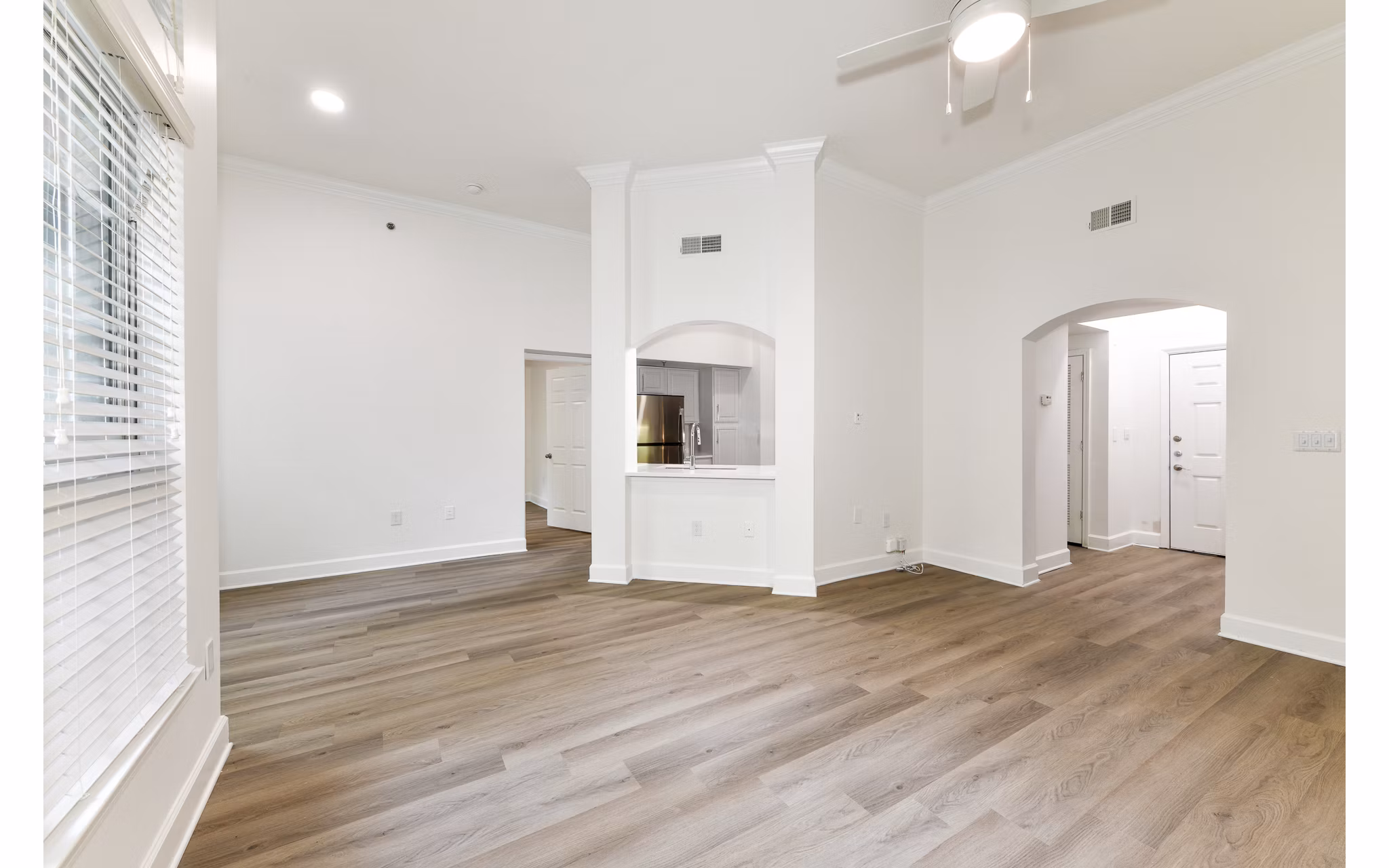 Spacious living room with modern furniture and large windows in Phipps Place Apartments