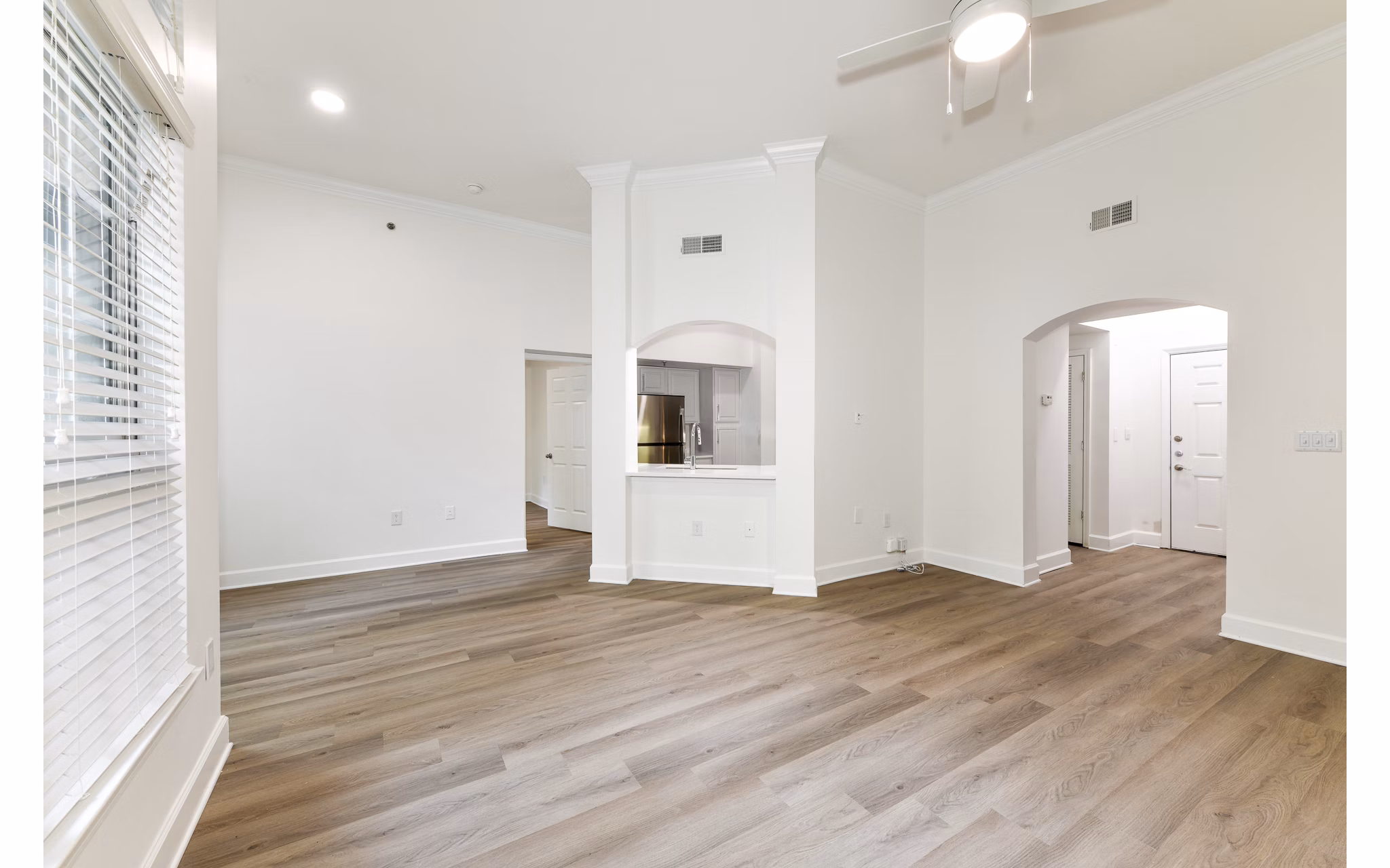 Spacious living room with modern furniture and large windows in Phipps Place Apartments