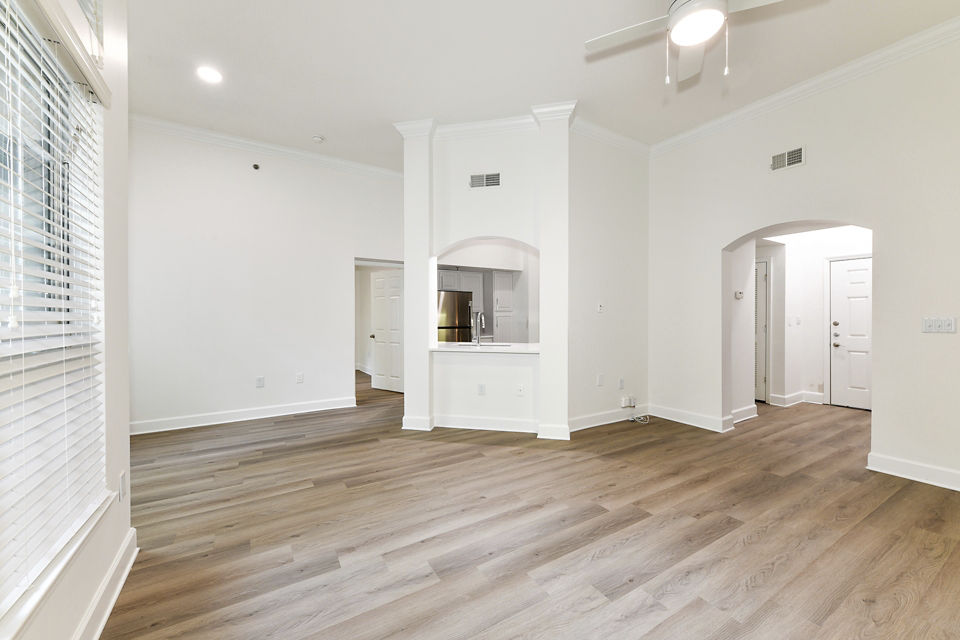 Spacious living room with modern furniture and large windows in Phipps Place Apartments