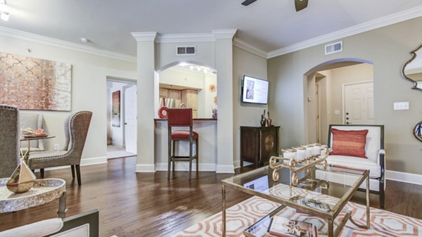 Spacious living room with modern decor and large windows in Phipps Place Apartments, a luxury Greystar community