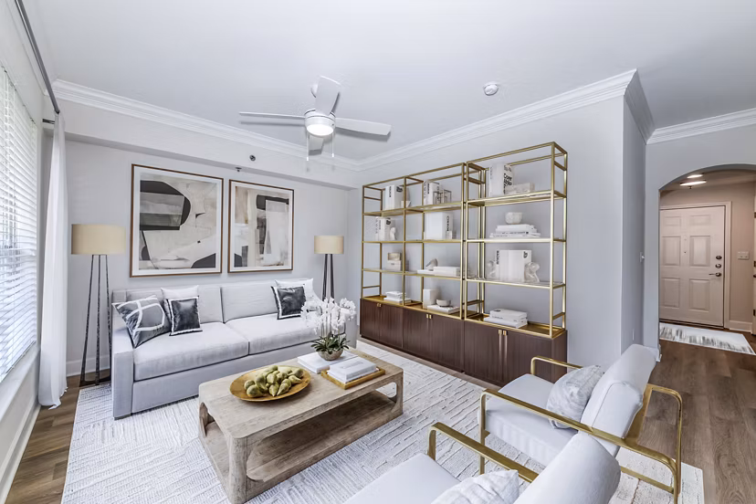 Living room with modern furniture and large windows at Phipps Place Apartments