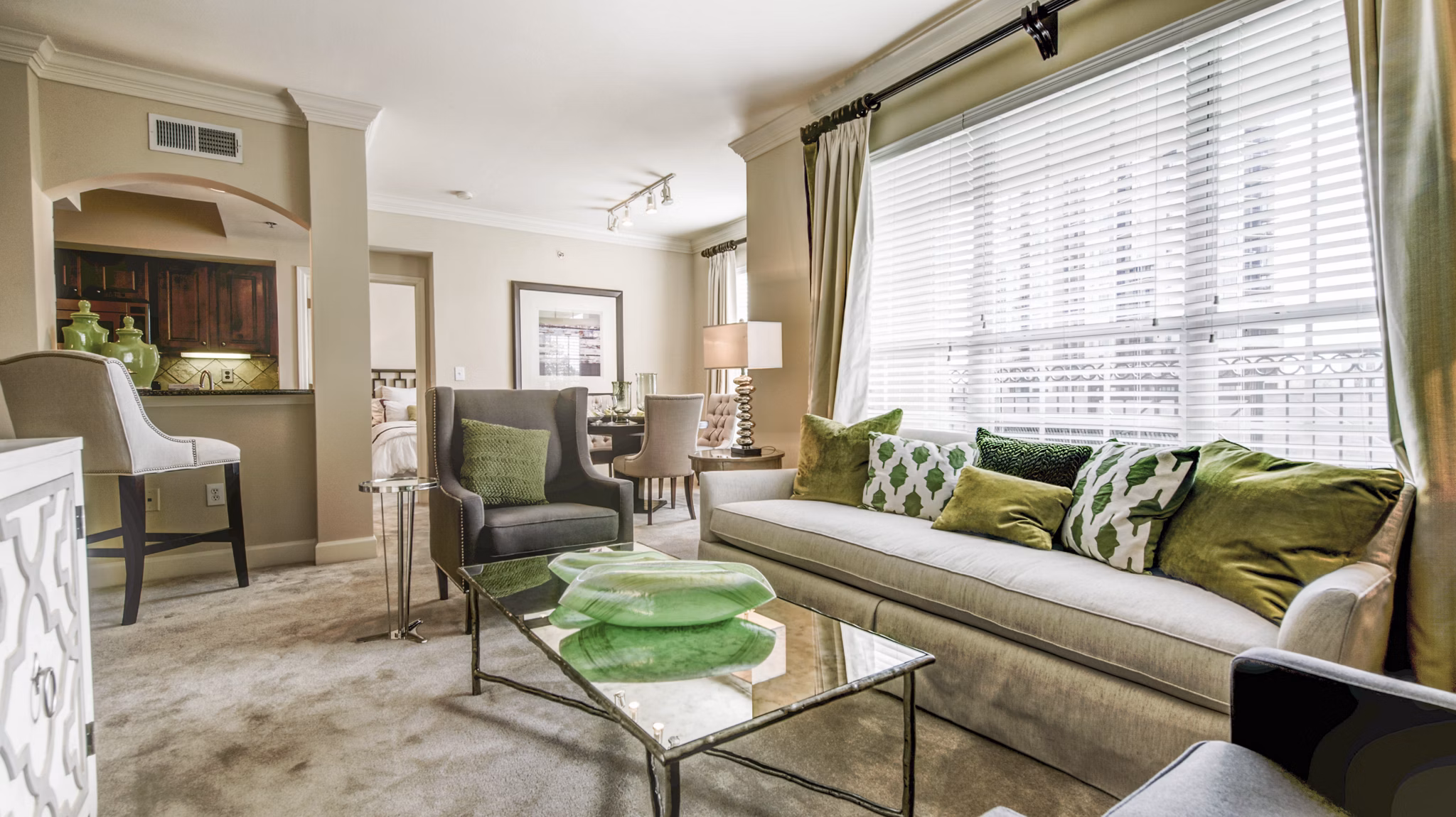 Modern living room featuring sleek furniture and large windows at Phipps Place Apartments