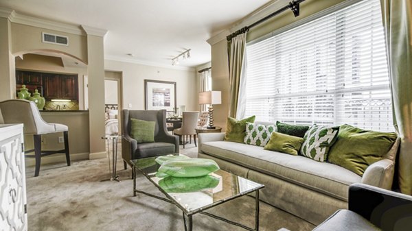 Modern living room featuring sleek furniture and large windows at Phipps Place Apartments