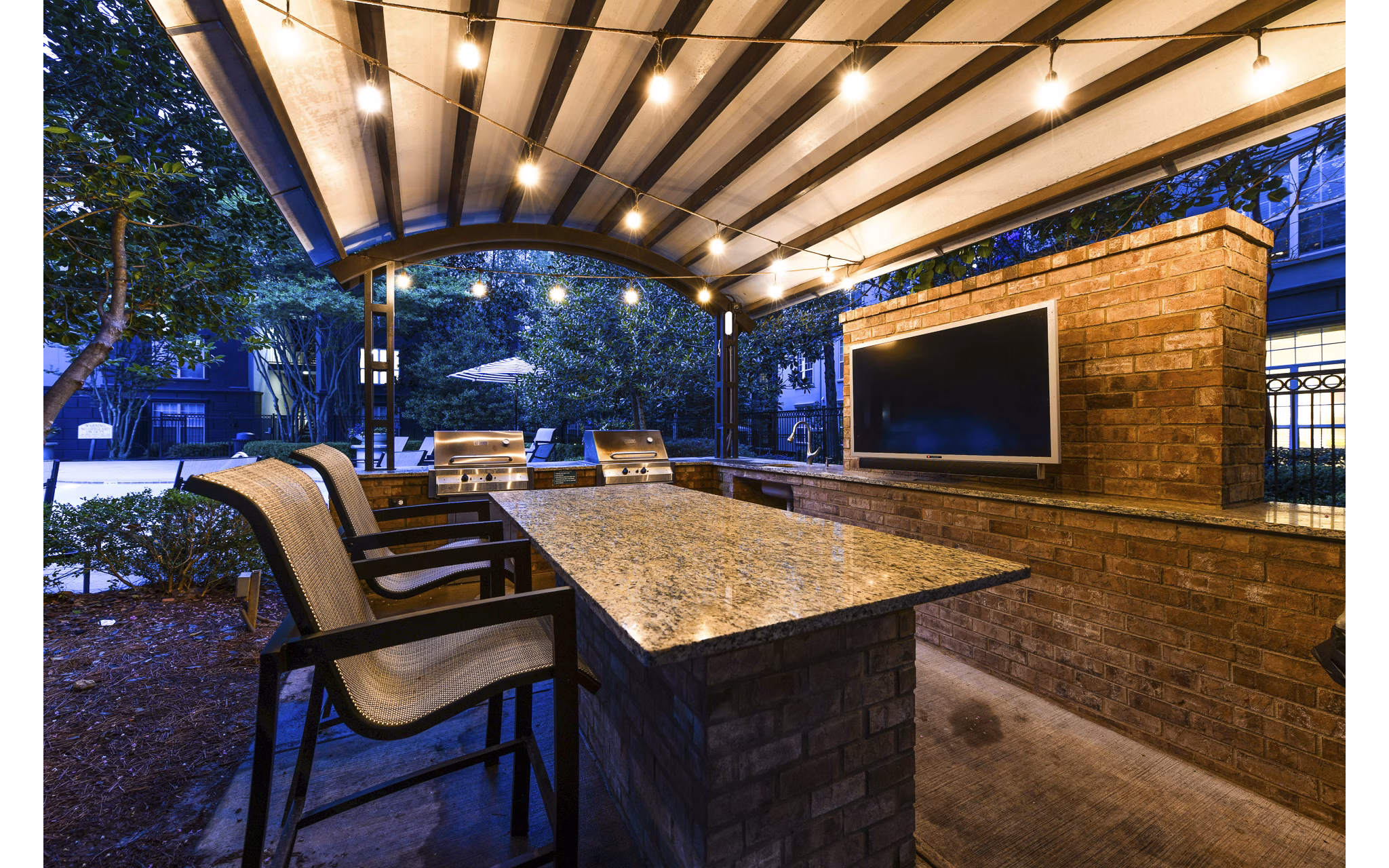Grill area with elegant patio seating at Phipps Place Apartments luxury community