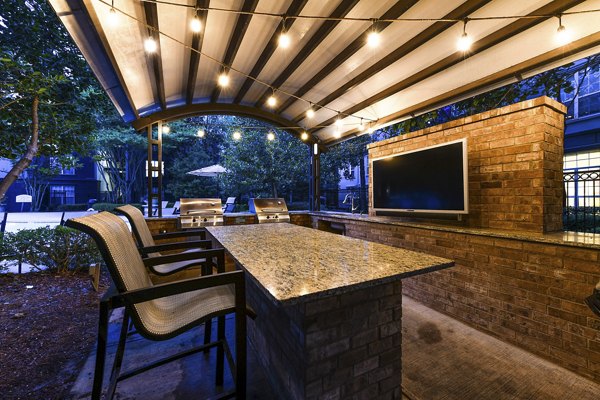 Grill area with elegant patio seating at Phipps Place Apartments luxury community