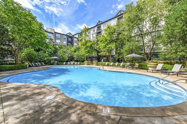 Phipps Place Apartments: Luxurious outdoor pool area with lounge seating and lush landscaping