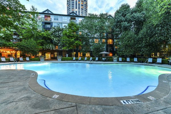 Luxurious pool at Phipps Place Apartments with sun loungers and lush landscaping