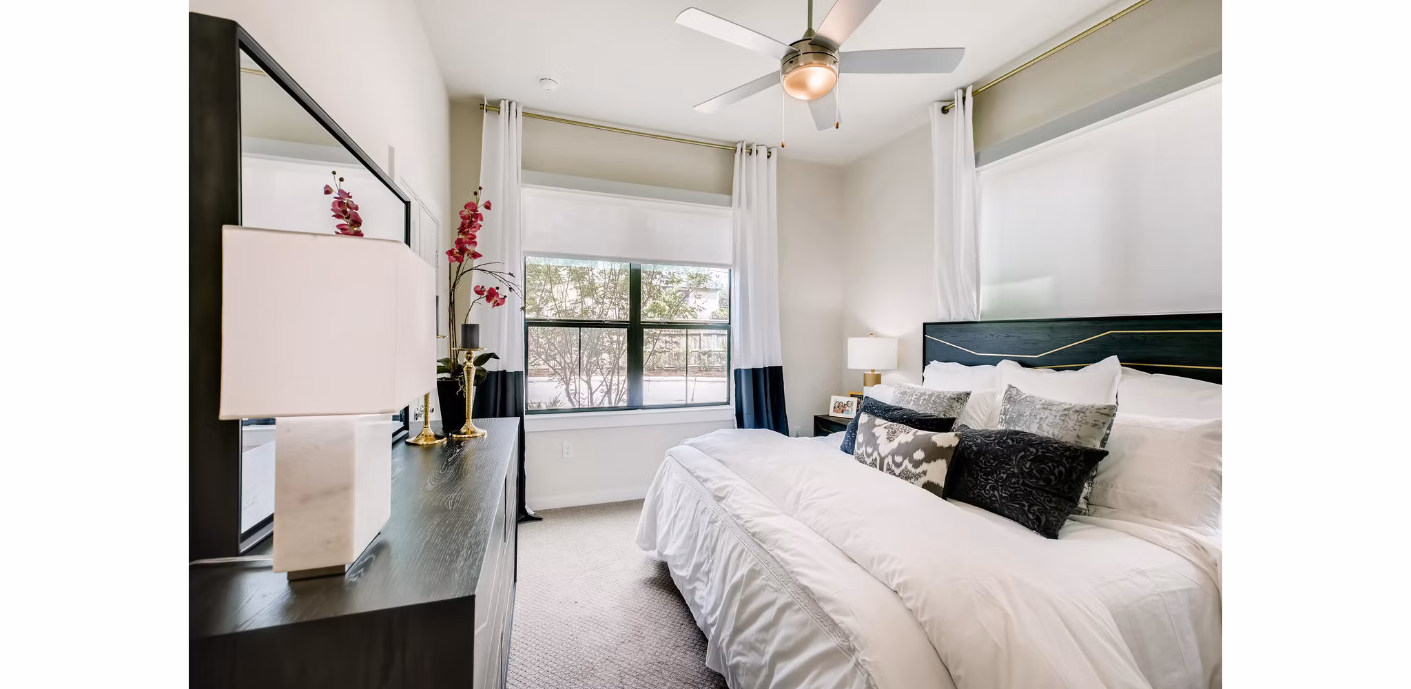 Bedroom featuring modern furnishings and neutral tones at The Caroline Apartments