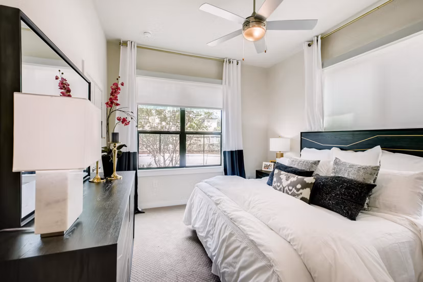 Bedroom featuring modern furnishings and neutral tones at The Caroline Apartments