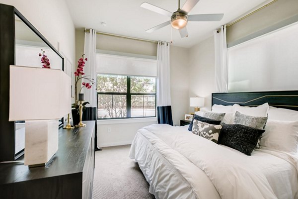 Bedroom featuring modern furnishings and neutral tones at The Caroline Apartments